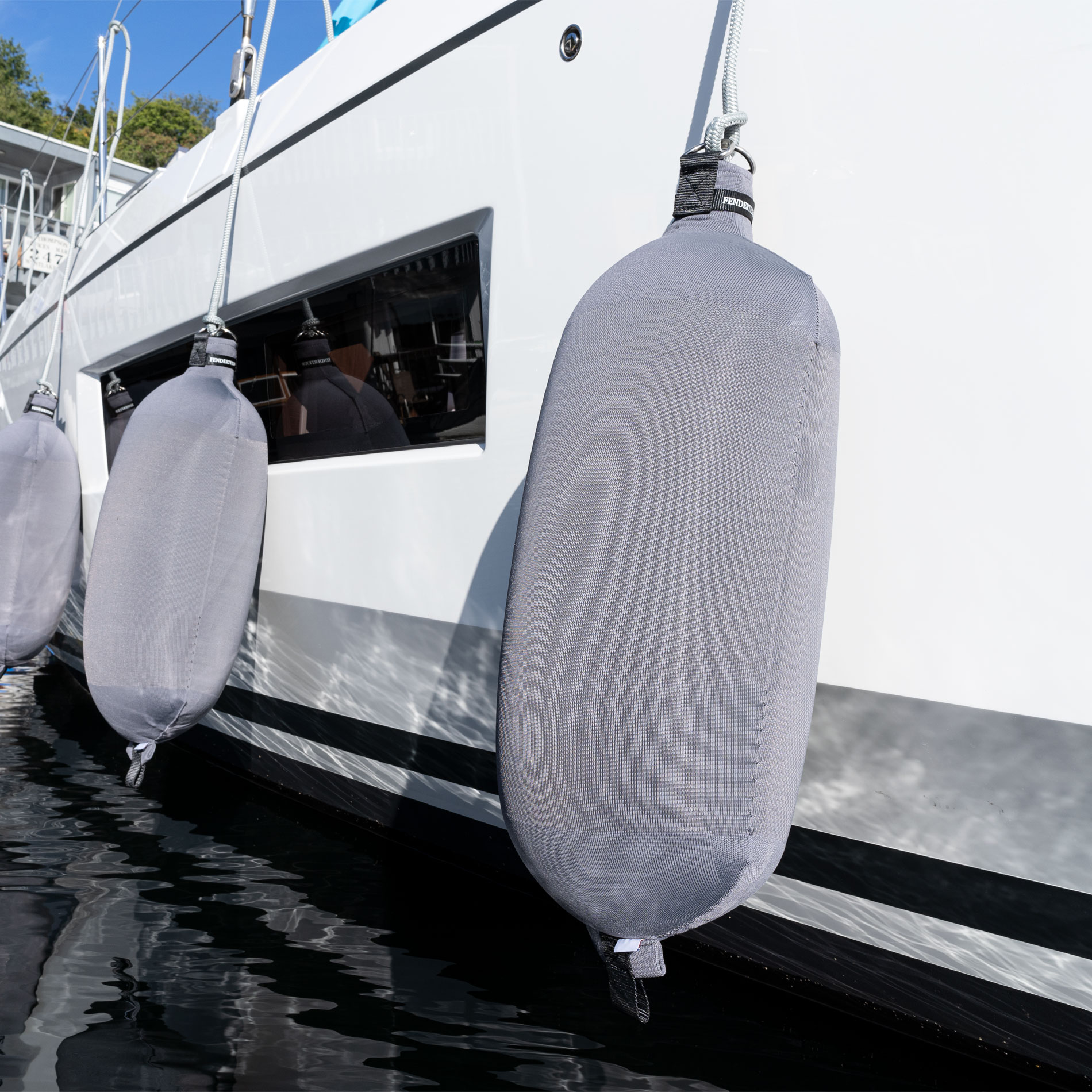 Grey Fendertex cylindrical fender on sailboat