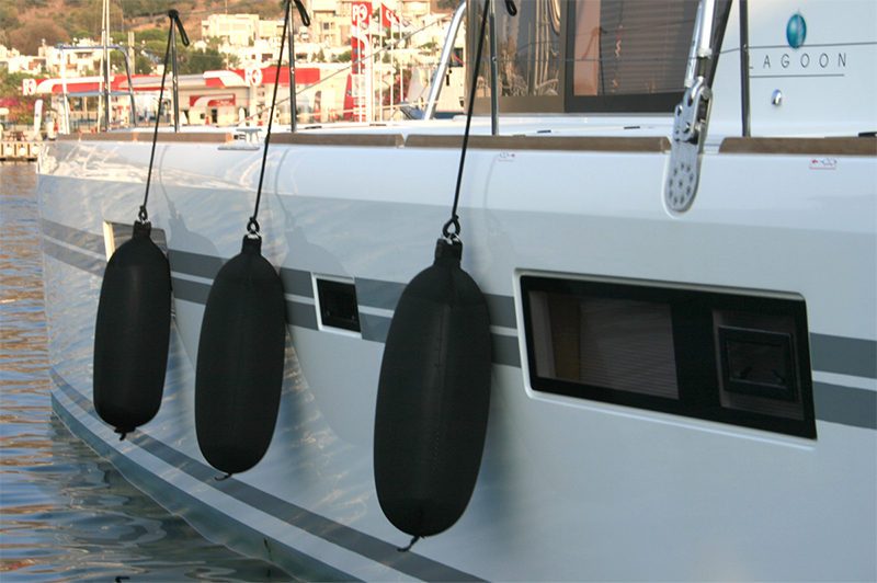 Black Fendertex fenders on catamaran