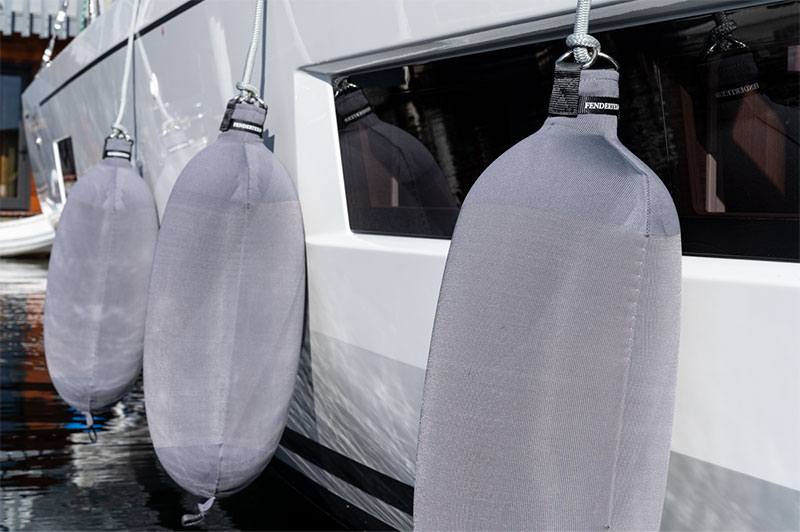 Grey Fendertex Cylindrical Fenders on a Beneteau sailboat