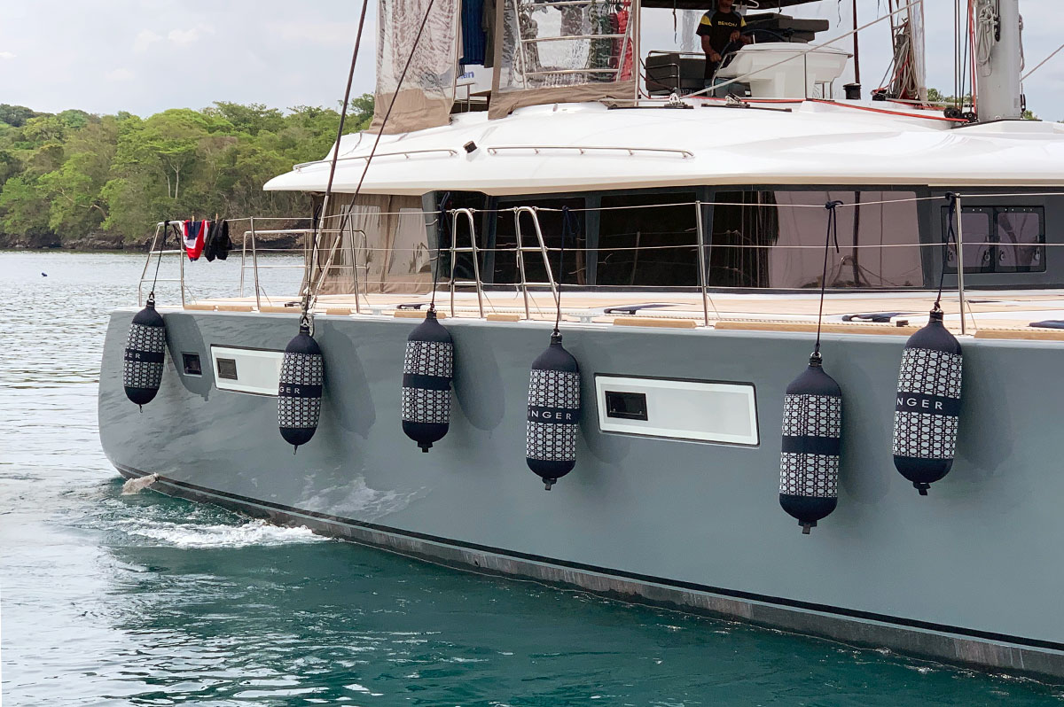 Custom navy blue Fendertex Fenders on a catamaran