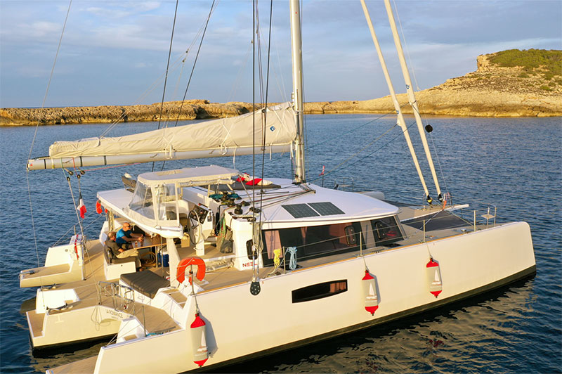 Custom orange and gray Fendertex Fenders on a catamaran