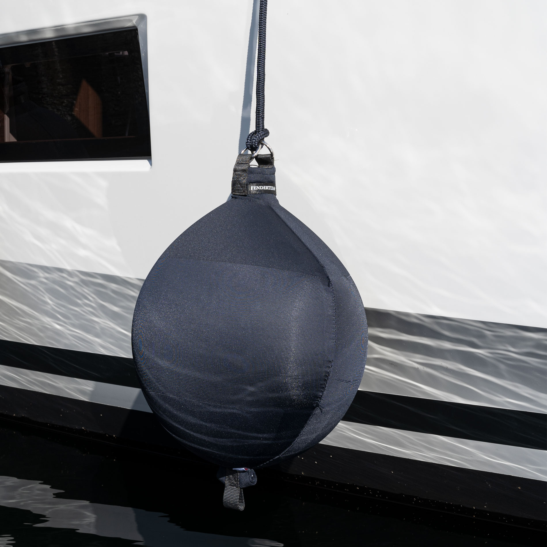Dark Grey Fendertex spherical fender on power boat